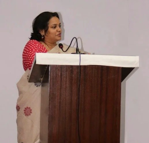 Preeti R. Bondre speaking at a lectern.